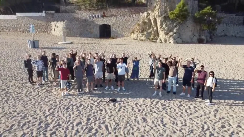 The Luzmo team together at a company offsite on the beach.