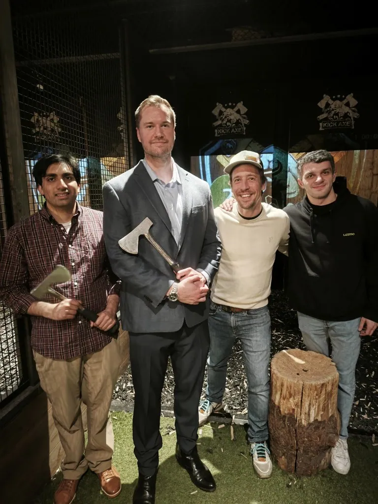 Luzmo team members at an axe-throwing team event.