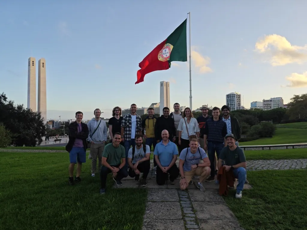 The Luzmo team gathered under a Portuguese flag in Lisbon.