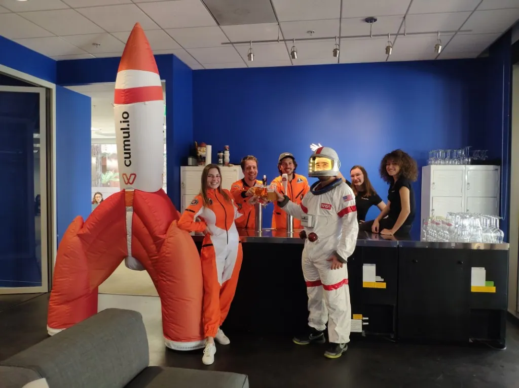 Luzmo team members in astronaut costumes celebrating at the office.